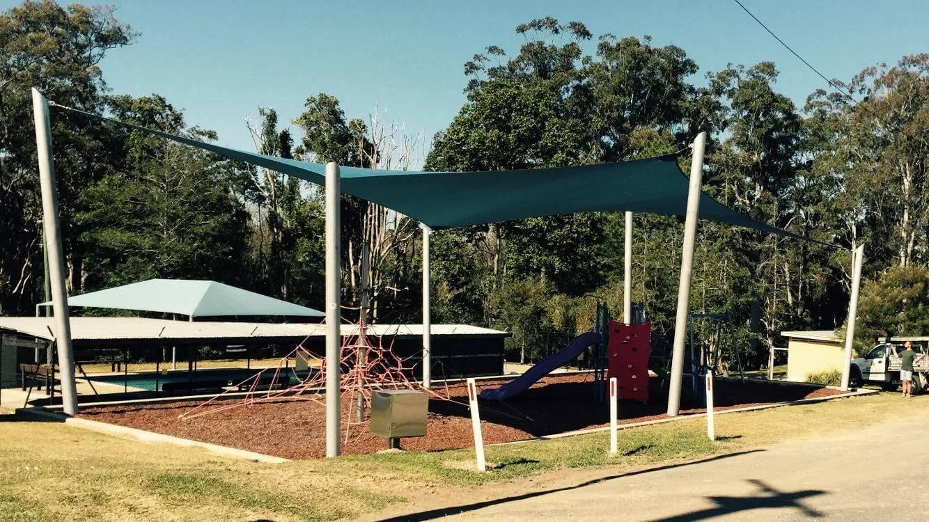 North Coast Shade installer fitting a charcoal shade sail